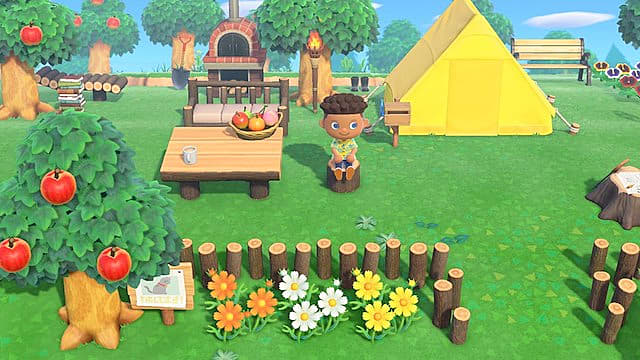 Assis près d'une tente et d'une table jaunes dans Animal Crossing New Horizons.