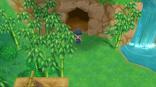 Le personnage du joueur se tient devant l'entrée d'une grotte près d'un étang, d'une cascade et de bambous. 