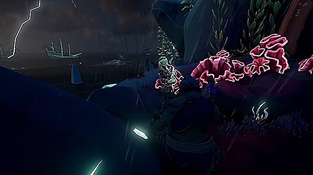 Un pirate fantomatique se tient à côté de corail rouge à la base d'une tour escarpée.