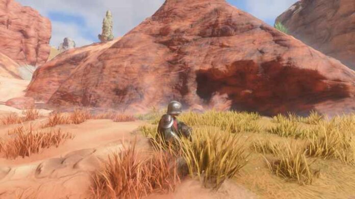 Character sitting in front of Sandstone in the Kindlewastes.