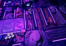 Tools and crafting items on a tarp in purple light in Sons of the Forest.