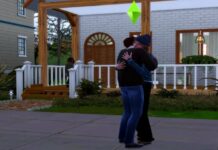 Two sims hugging in front of a house