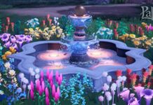 Fountain surrounded by flowers.